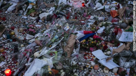 A memorial commemorates the victims of the Paris attacks on a street in Paris, France on Monday, November 16.