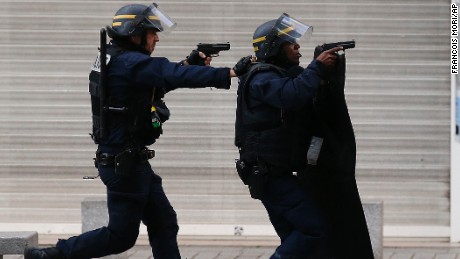 Armed police  operate in Saint-Denis, a northern suburb of Paris, Wednesday, Nov. 18, 2015. Police say two suspects in last week&#39;s Paris attacks, a man and a woman, have been killed in a police operation north of the capital. Two police officers have been injured in the standoff. Police have said the operation is targeting the suspected mastermind of last week&#39;s attacks, believed to be holed up in an apartment in Saint-Denis with several other heavily armed suspects. (AP Photo/Francois Mori)