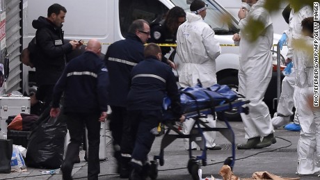 A body is removed from the apartment raided by French Police special forces earlier in the northern Paris suburb of Saint-Denis, on November 18, 2015, hunting those behind the attacks that claimed 129 lives in the French capital five days ago. French police said the assault had concluded on an apartment in northern Paris in which at least two jihadists were killed and seven arrested. AFP PHOTO / ERIC FEFERBERG        (Photo credit should read ERIC FEFERBERG/AFP/Getty Images)