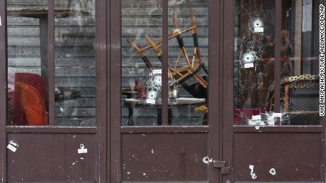 Bullet holes in the Café Bonne Bière storefront are a reminder of the carnage.