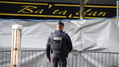 A police officer stands guard outside the concert hall days after the attacks.