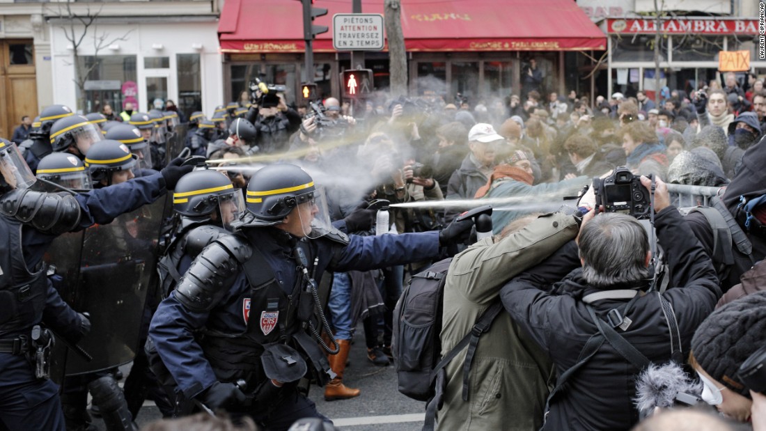 Police fight with activists during a protest ahead of the 2015 Paris Climate Conference at the Place de la République.