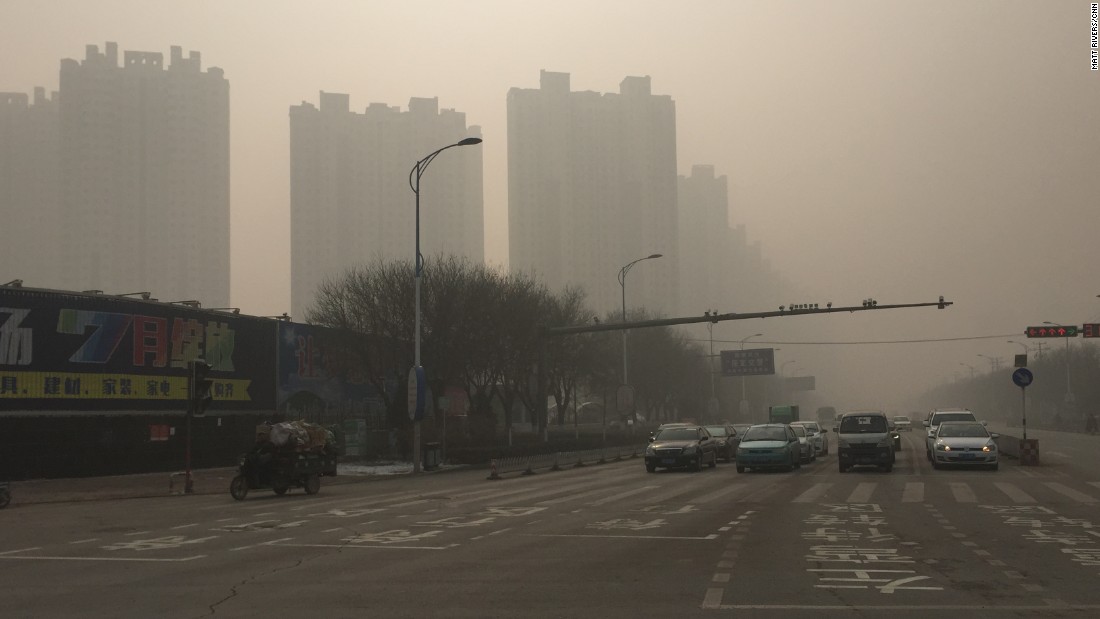 Roads and buildings in Baoding, China&#39;s most polluted city, are cloaked in thick smog on November 30, where the air quality index (AQI) has reached a &#39;hazardous&#39; level.