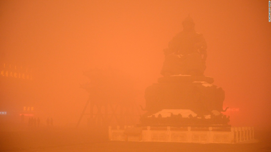 A Genghis Khan statue is obscured by a cloak of orange-tinged smog on November 29, 2015 in Hohhot, capital of Inner Mongolia, China.