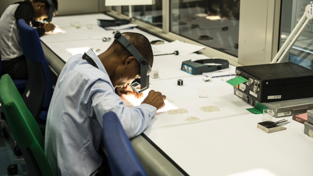 An employee inspects rough diamonds at De Beers&#39; Global Sightholder Sales facility in Gaborone, the largest inspection and valuation operation in the world.