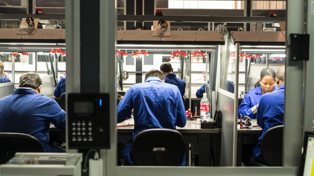 KGK Diamonds employees cut the final facets on round cut diamonds at the company&#39;s Gaborone factory.