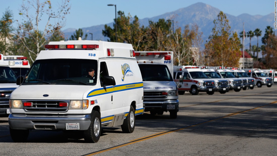 Ambulances pull out of a staging area near the Inland Regional Center.