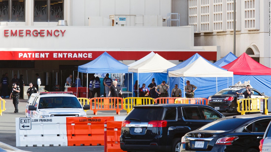 Police stand guard outside of the emergency room at the Loma Linda University Medical Center, where some of the victims were being treated.