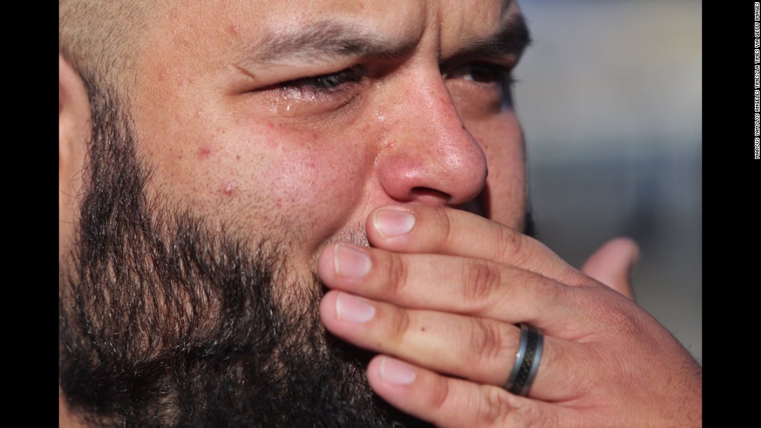 Luis Gutierrez gets emotional as he talks about his wife who works in the facility and saw a gunman, according to Los Angeles Times photographer Marcus Yam.