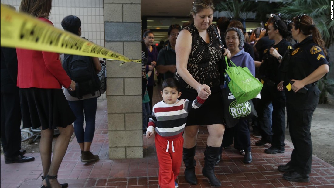 People leave a community center after reuniting with friends and family in the aftermath of the shootings.