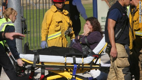 A victim is wheeled away on a stretcher following a shooting that killed multiple people at a social services facility, Wednesday, Dec. 2, 2015, in San Bernardino, Calif. (David Bauman/The Press-Enterprise via AP)  MAGS OUT; MANDATORY CREDIT; LOS ANGELES TIMES OUT