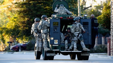 SAN BERNARDINO, CA - DECEMBER 02:  SWAT officers enter an area where suspects were believed to be after the shooting at the Inland Regional Center on December 2, 2015 in San Bernardino, California.  Police continue to search for suspects in the shooting that left at least 14 people dead and another 17 injured.   (Photo by Sean M. Haffey/Getty Images)