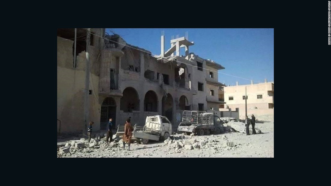 In this photo from November 29, 2015, provided to CNN by the activist group Raqqa is Being Slaughtered Silently, residents assess the damage to a building in the northern Syrian city -- ISIS&#39;s headquarters -- which has been the target of French airstrikes in recent weeks.