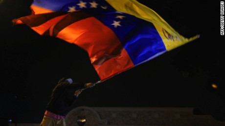 Venezuelan opposition supporters celebrate the results of the legislative election in Caracas, on the early morning December 7, 2015. Venezuela's opposition won --at least--a majority of 99 out of 167 seats in the state legislature, electoral authorities said Monday, the first such shift in power in congress in 16 years. AFP PHOTO/LUIS ROBAYOLUIS ROBAYO/AFP/Getty Images