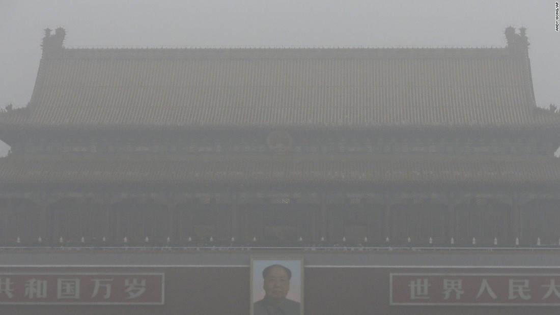 Tiananmen Gate stands shrouded with heavy pollution and fog in Beijing on December 1, 2015. Previously under an orange alert, the second-highest warning level, the Chinese capital enters yet another week choked by toxic smog under the newly issued red alert -- due to be in force until noon of December 10 local time.