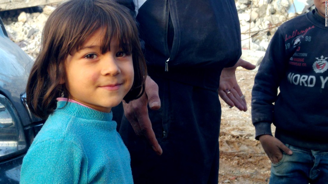 A young resident of Kobani. She stood by her father, Mustafa Ismail, who watched silently for hours as a bulldozer hauled away the remains of his three-story house.