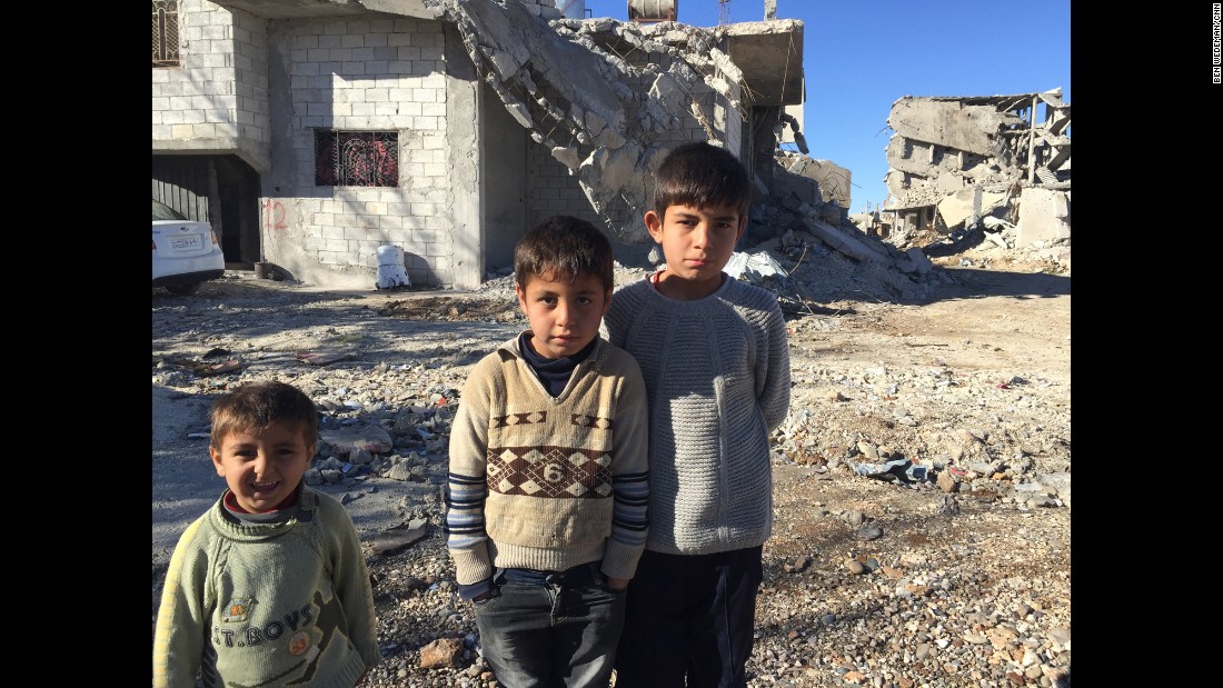 The Muhajar brothers -- Yusif, 3, Mustafa, 8, and Ali, 11 -- in front of their partially destroyed house in Kobani. As someone pointed out to CNN&#39;s Ben Wedeman, the expressions from youngest to oldest go from smiling to frowning.