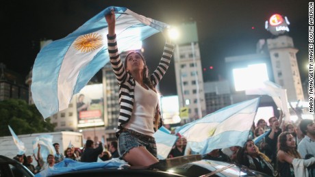 BUENOS AIRES, ARGENTINA - NOVEMBER 22: Supporters of President-elect Mauricio Macri wave Argentinian flags in the street celebrating after he defeated ruling party candidate Daniel Scioli in a runoff election on November 22, 2015 in Buenos Aires, Argentina. Argentina faced its first presidential election runoff in the history of the country with Macri winning and ending 12 years of Peronist rule. (Photo by Mario Tama/Getty Images,)