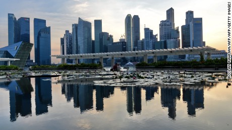 A general view of the financial district skyline is reflected in a pond in Singapore on March 6, 2014 in Singapore. Singapore played down a global survey showing that it is now the world&#39;s most expensive city, a finding which has triggered outrage among Singaporeans struggling with rising costs. AFP PHOTO / ROSLAN RAHMAN        (Photo credit should read ROSLAN RAHMAN/AFP/Getty Images)