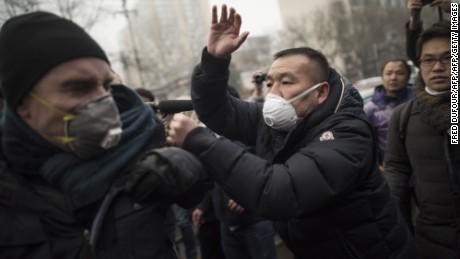Chinese police push away journalists and supporters of human rights lawyer Pu Zhiqiang demonstrating near the Beijing Second Intermediate People&#39;s Court in Beijing on December 14, 2015. One of China&#39;s most celebrated human rights lawyers went on trial December 14 over online comments critical of the ruling Communist Party, as police scuffled with supporters and journalists gathered outside the courthouse. AFP PHOTO / FRED DUFOUR / AFP / FRED DUFOUR        (Photo credit should read FRED DUFOUR/AFP/Getty Images)