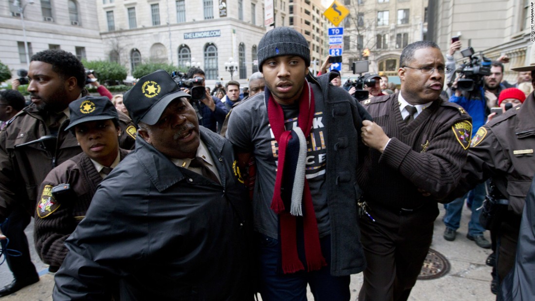 A demonstrator is detained outside a Baltimore courthouse on Wednesday, December 16, after the &lt;a href=&quot;http://www.cnn.com/2015/12/16/us/baltimore-police-trial-freddie-gray/index.html&quot; target=&quot;_blank&quot;&gt;mistrial of William Porter,&lt;/a&gt; one of six Baltimore police officers charged in connection with the death of Freddie Gray. Jurors said they were deadlocked and unable to reach a unanimous verdict.