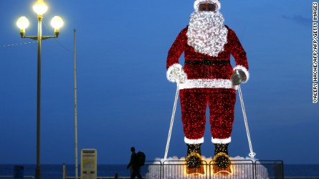 TOPSHOT - A giant illuminated Santa Claus model is displayed along the &quot;Promenade des Anglais&quot; in the French Riviera city of Nice, southeastern France, on December 12, 2015.  / AFP / VALERY HACHE        (Photo credit should read VALERY HACHE/AFP/Getty Images)