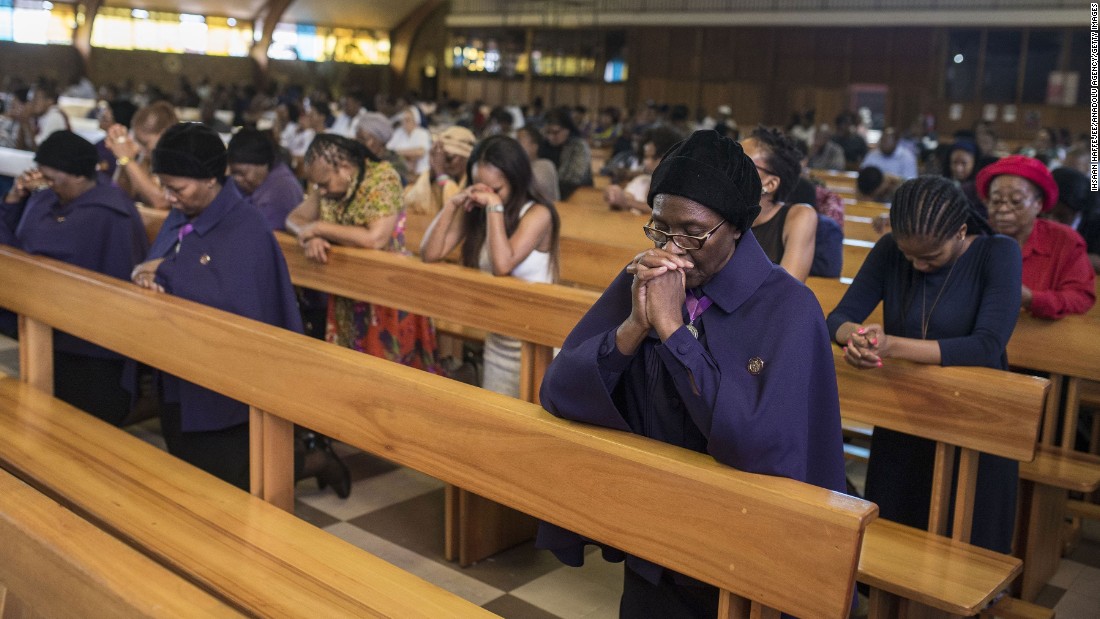 People pray as they attend a Christmas Mass at the Regina Mundi Church in Soweto, South Africa.