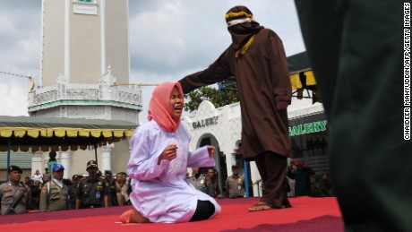 A young woman is caned in public on December 28 for violating Sharia law in Banda Aceh, Indonesia.