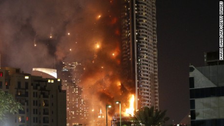 Flames rip through the Address Downtown hotel after it was hit by a massive fire, near the world's tallest tower, Burj Khalifa, in Dubai, on December 31, 2015. People were gathering to watch New Year's Eve celebrations when the hotel caught on fire, with the cause of the blaze still unknown according to the emirate's police chief. AFP PHOTO / KARIM SAHIB / AFP / KARIM SAHIB        (Photo credit should read KARIM SAHIB/AFP/Getty Images)