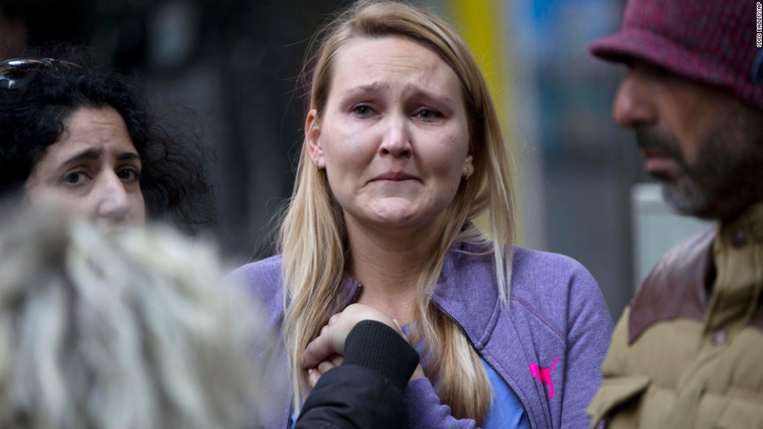 A woman cries at the scene of the shooting.