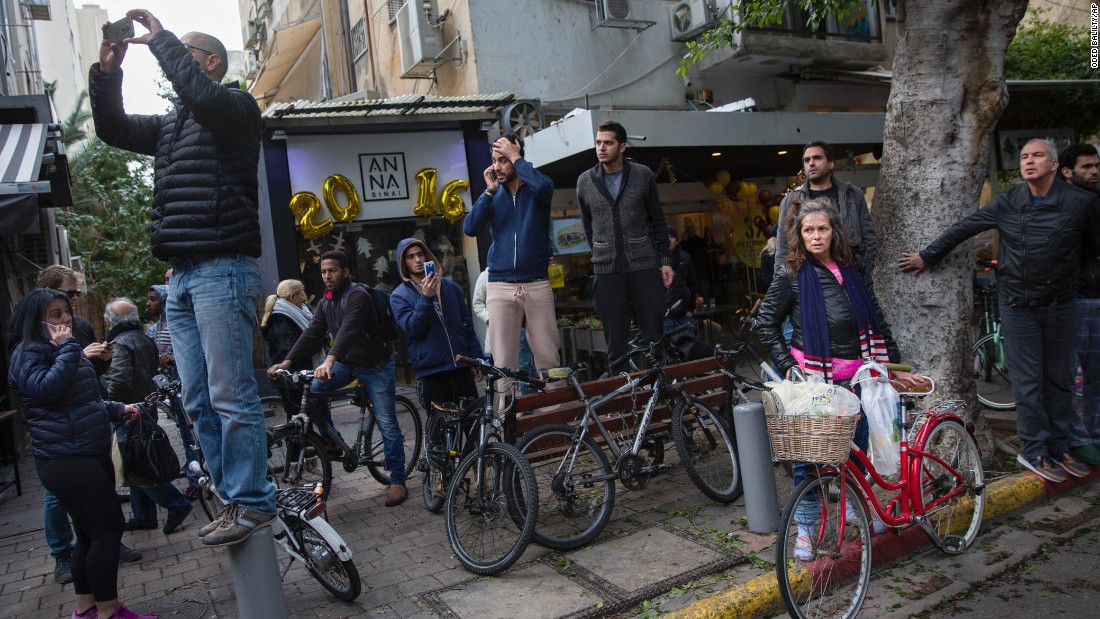 People gather near the attack site.