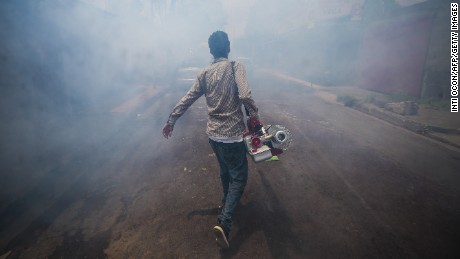 A worker fumigates against the Aedes aegypti mosquito to prevent the spread disease. 