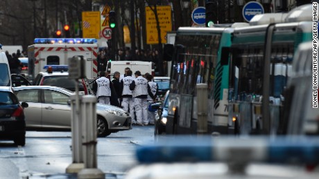 Rescue workers are seen at the Boulevard de Barbes in the north of Paris on January 7, 2016, after police shot a man dead as he was trying to enter a police station in the Rue de la Goutte d&#39;Or. The man shot dead by police on the first anniversary of the jihadist assault on Charlie Hebdo had a knife and what appeared to be an explosives vest, the government said. The man was also heard to shout &quot;Allahu Akbar&quot; as he approached the police station in the multi-ethnic neighbourhood in the north of the capital, the interior ministry said. AFP PHOTO / LIONEL BONAVENTURE / AFP / LIONEL BONAVENTURE        (Photo credit should read LIONEL BONAVENTURE/AFP/Getty Images)