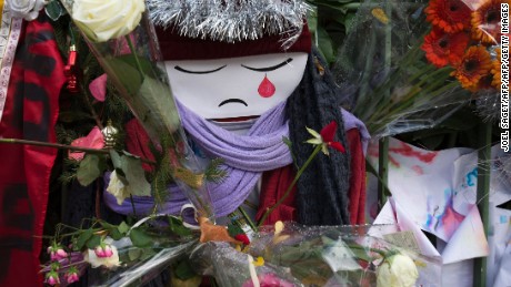 TOPSHOT - A doll crying is seen among flowers at a makeshift memorial in tribute to the victims of the Paris terror attacks, on January 4, 2016, outside the Bataclan concert hall in Paris, ahead of the one year anniversary of the jihadist attack on French satirical weekly newspaper Charlie Hebdo.
Eight Charlie Hebdo staff were among the victims of the January 7, 2015 assault which brought millions of people onto France&#39;s streets in protest and transformed a fading publication into a global symbol of freedom of expression. / AFP / JOEL SAGET        (Photo credit should read JOEL SAGET/AFP/Getty Images)