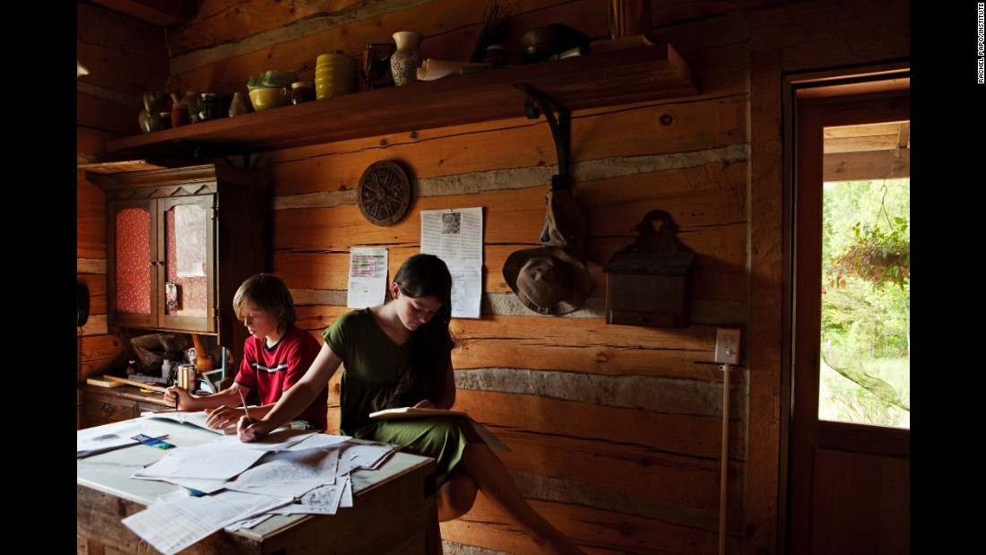 Iris and Roan, two homeschooled children in rural New York, do homework in 2012. They live on a family farm with their parents, who follow a nature-based learning method and believe their children would benefit more from spending their time within nature and at home rather than on a school bus and in a classroom, photographer Rachel Papo said. Papo spent time with about 15 homeschooled children over two years, and her photos will be published in a book this spring.
