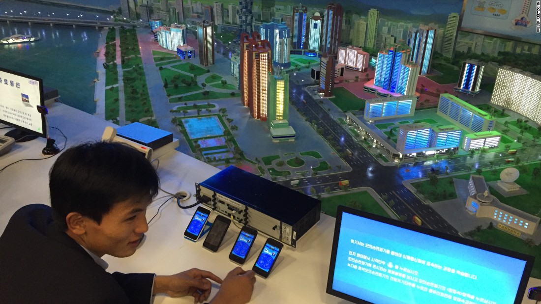 A guide shows visitors a display in the North Korean Science and Technology Center.