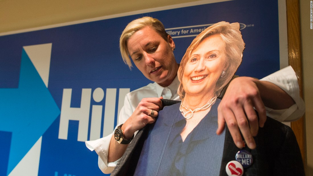 Former U.S. Women&#39;s National Soccer Team captain Abby Wambach puts her jacket on a cardboard cutout of Clinton before speaking to a crowd at a Clinton campaign office on January 8, 2016 in Salem, New Hampshire. 