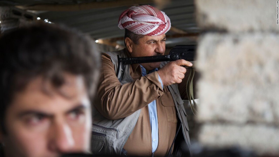 Peshmerga fighters train their guns on the front line in northern Iraq, which children try to reach after fleeing ISIS.