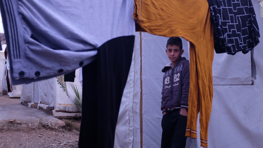 Ayman Salih, 12, pictured at the Esyan refugee camp, had been held in Mosul by ISIS at its training facility.