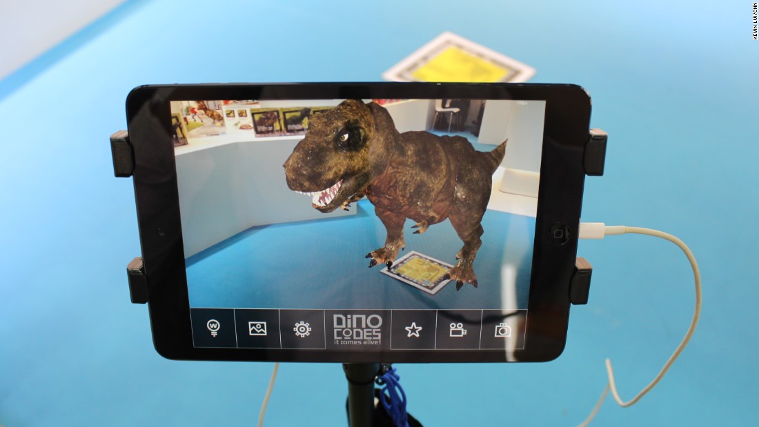 ...only to find a DNA barcode, which triggers -- in the manufacturer&#39;s complementary mobile app -- an animation of the same dinosaur whose bones you&#39;ve just excavated. The app allows players to take photos and videos posing with the computer-generated creature.