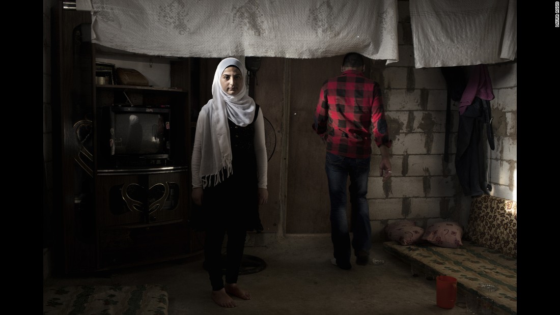Amal, 14, left Syria with her family three years ago. Her future husband is 28-year-old Ahmad, right. The family wants to marry her off, and she agrees with this decision, said photographer Laura Aggio Caldon. Many Syrian refugees are marrying off their children to protect them from war and poverty.