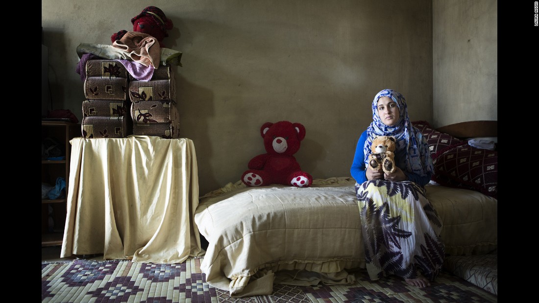 Rukayya, 14, holds a plush bear that was given to her as an engagement gift. Her mother said she would never have wanted one of her daughters to get married so young, but the crisis in Syria has changed everything.