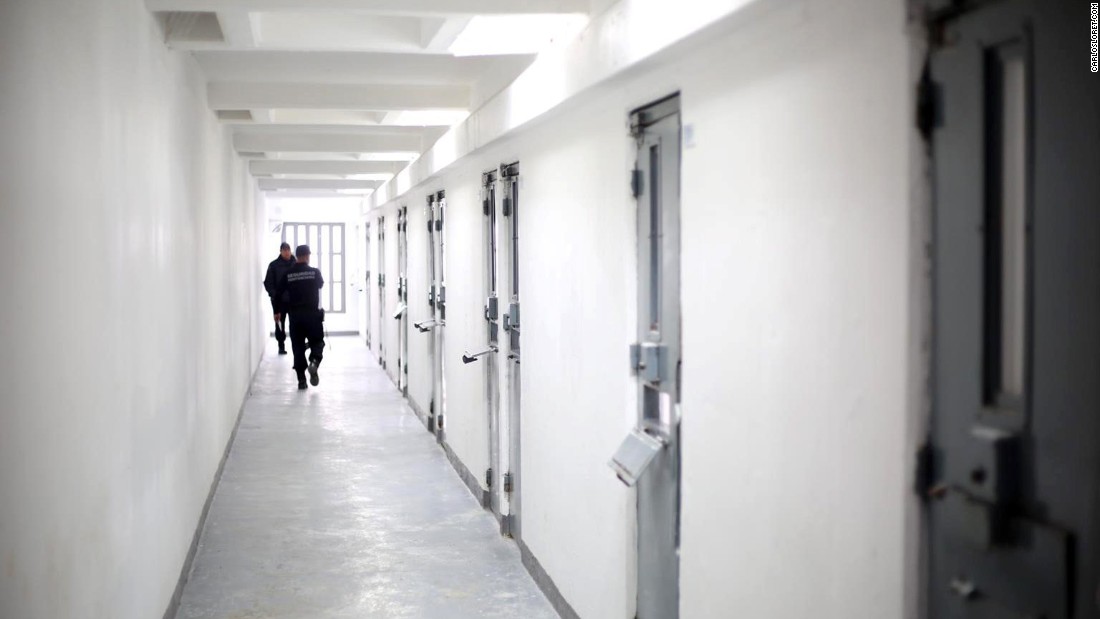 Guards walk down a hallway of the prison, which has installed 400 new cameras. Authorities hope to add another 600 by April.