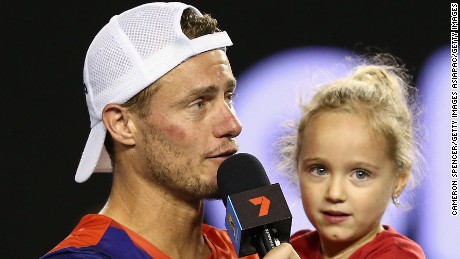 Lleyton Hewitt speaks on court with his daughter Ava after losing his final match at the 2016 Australian Open.