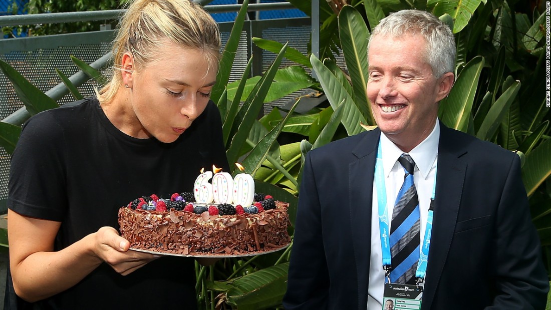 The Russian star was given a cake to mark the occasion. Tournament director Craig Tiley looks on enviously ...