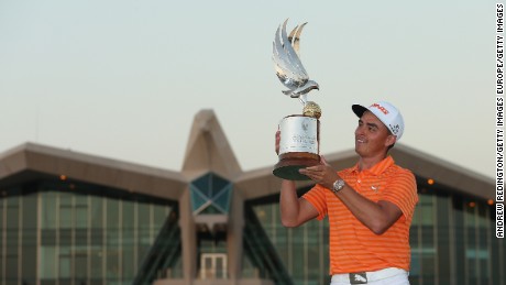 Rickie Fowler poses with the winning trophy after claiming the Abu Dhabi Championship.