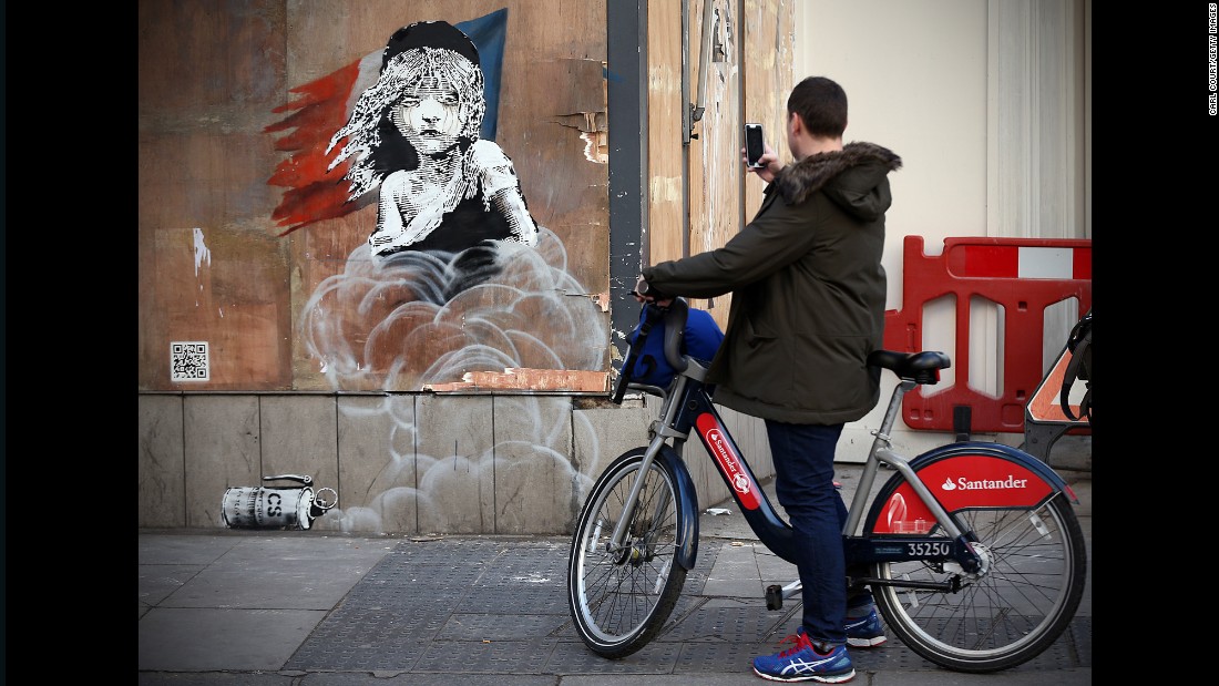 On January 25, a new mural by street artist Banksy appeared on the French Embassy in London, criticising the French authorities&#39; reported use of teargas in a refugee camp in Calais, France. A riff on the iconic Les Misérables poster, it shows a young girl enveloped by CS gas, crying.
