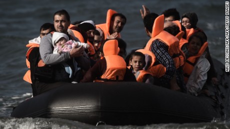 Refugees and migrants cross by boat the Aegean sea from Turkey, to reach the Greek island of Lesbos, on October 31, 2015. AFP PHOTO / ARIS MESSINIS        (Photo credit should read ARIS MESSINIS/AFP/Getty Images)