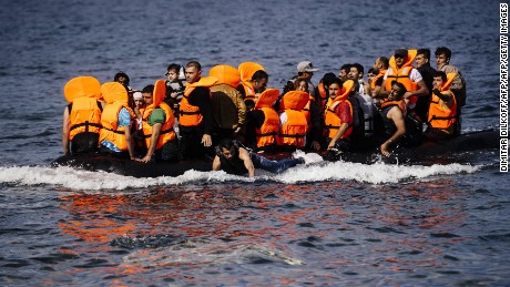 Migrants arrive on the Greek island of Lesbos after crossing the Aegean sea from Turkey October 18, 2015.