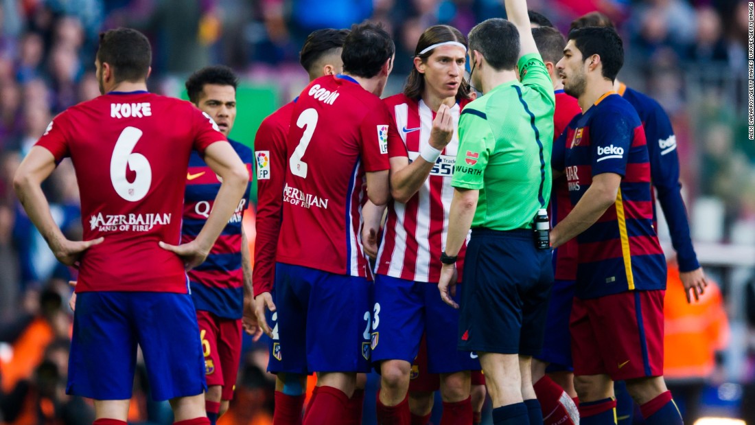 Referee Alberto Undiano Mallenco shows a red card to Filipe Luis after fouling Lionel Messi.